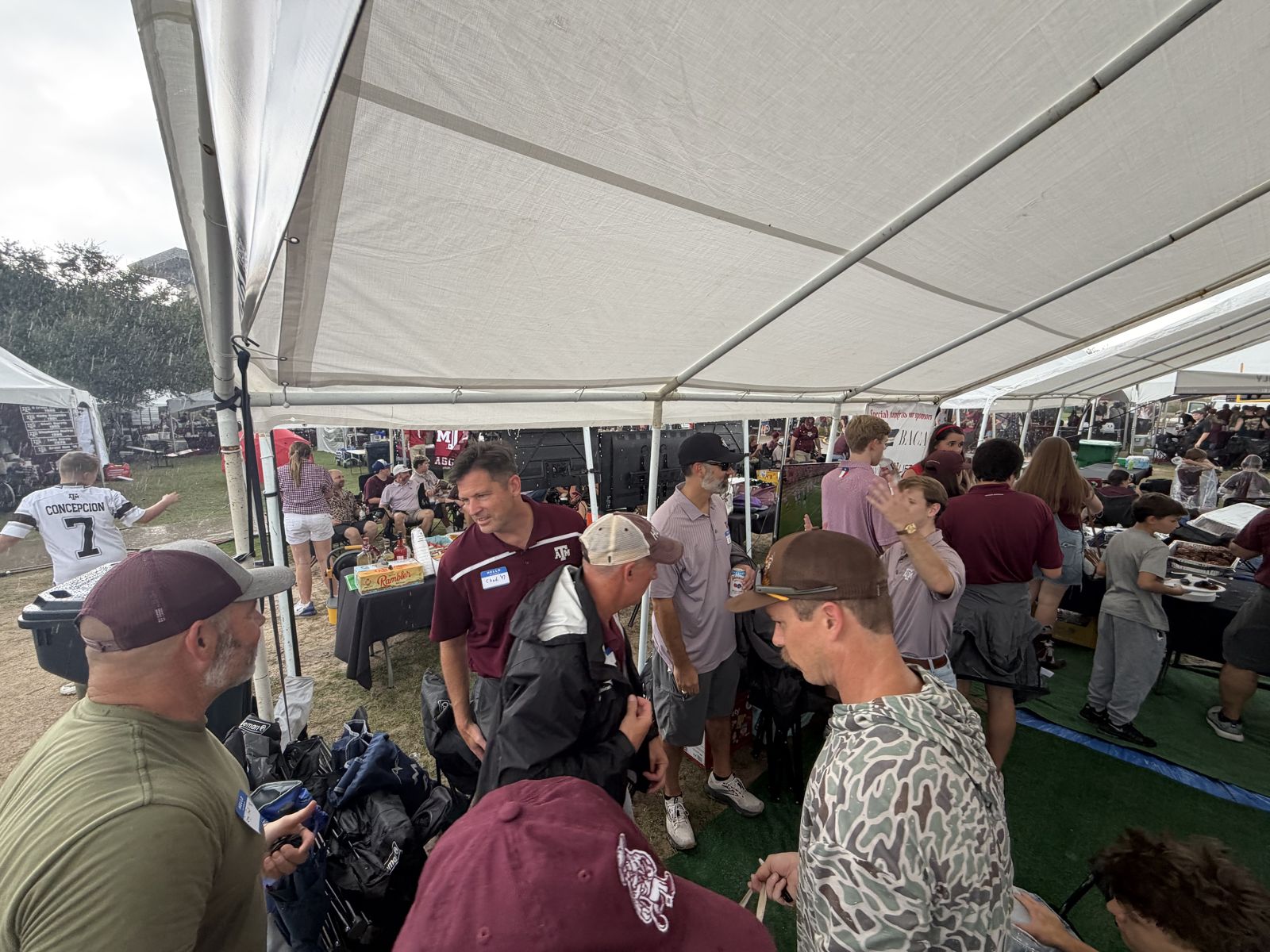 Alumni and actives talking under the tent